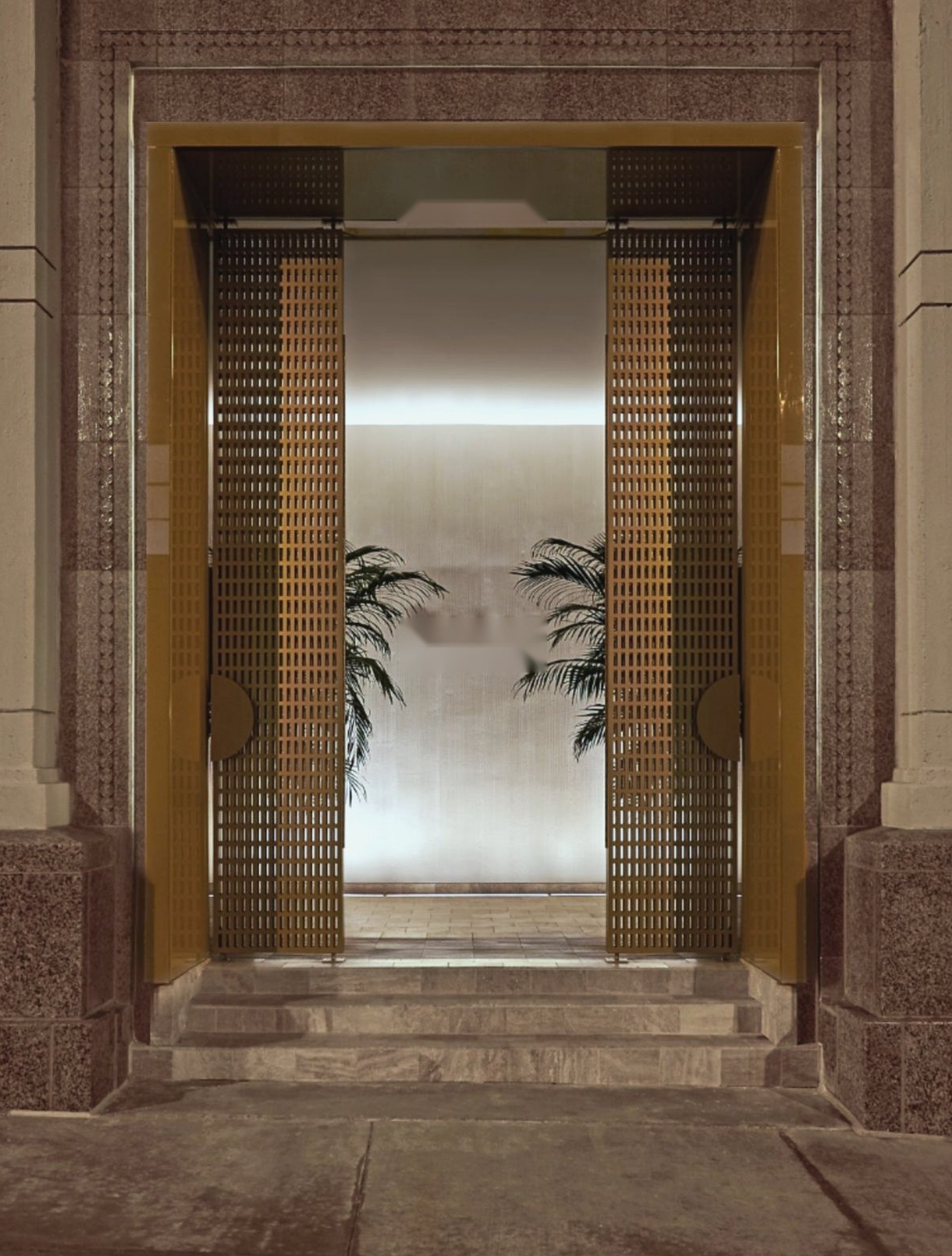 The bronze lattice doors at the entrance to Accel House